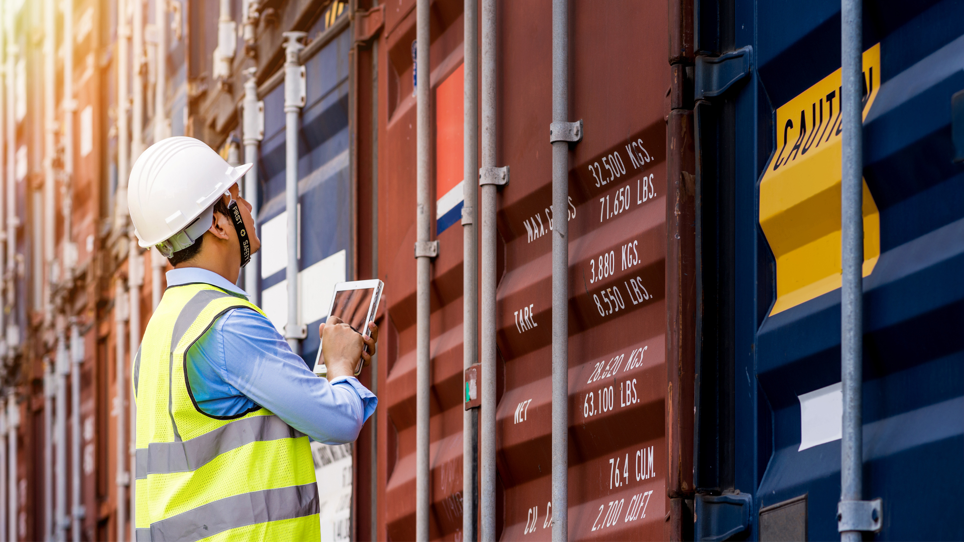 Foreman control loading Containers box from Cargo Colored Containers