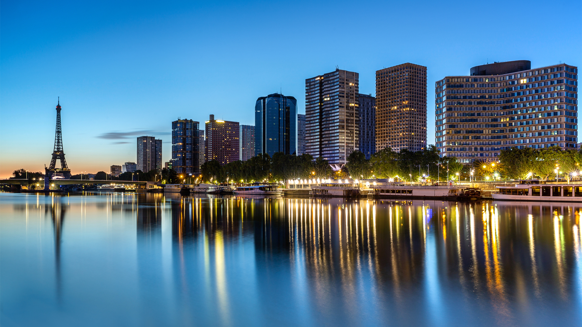 Skyline view of Paris France with office buildings and Tower at sunset