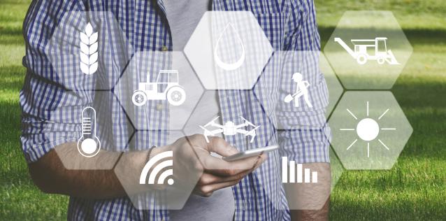 man on grass with phone on hand with agriculture icons overlay