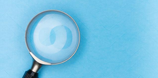 Magnifying glass on a blue background